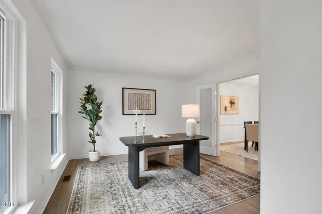 a view of a dining room with a table and chairs