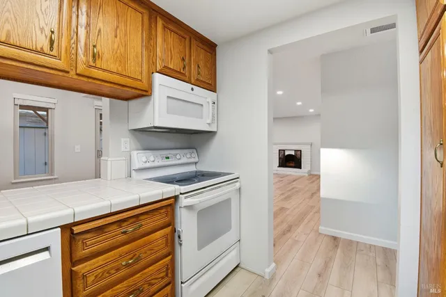 a kitchen with stainless steel appliances granite countertop a stove and a refrigerator