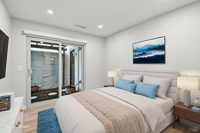 a bedroom with a bed and a large mirror