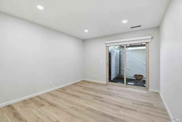 a view of a room with wooden floor