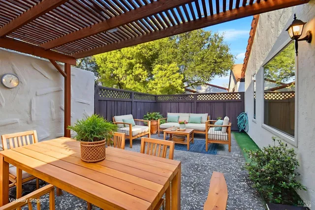 a view of a patio with a table chairs and a potted plant