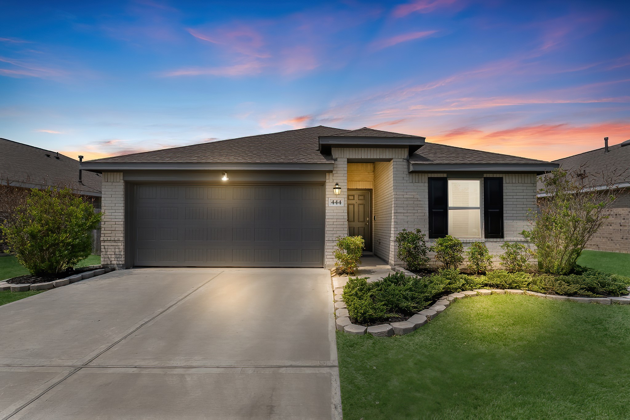 a front view of a house with garden
