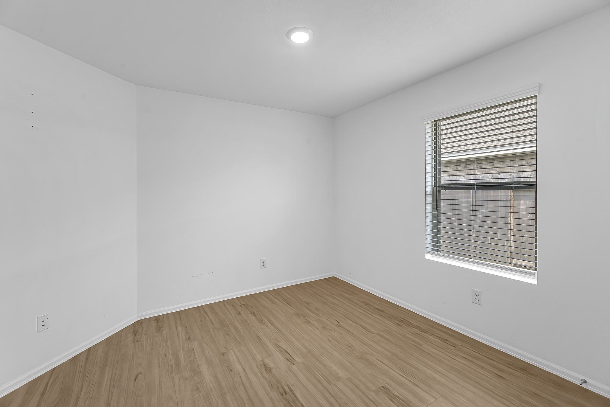 444 Maple Bend Lane La Marque, TX 77568 - Photo 18 of 32 wooden floor in an empty room with a window