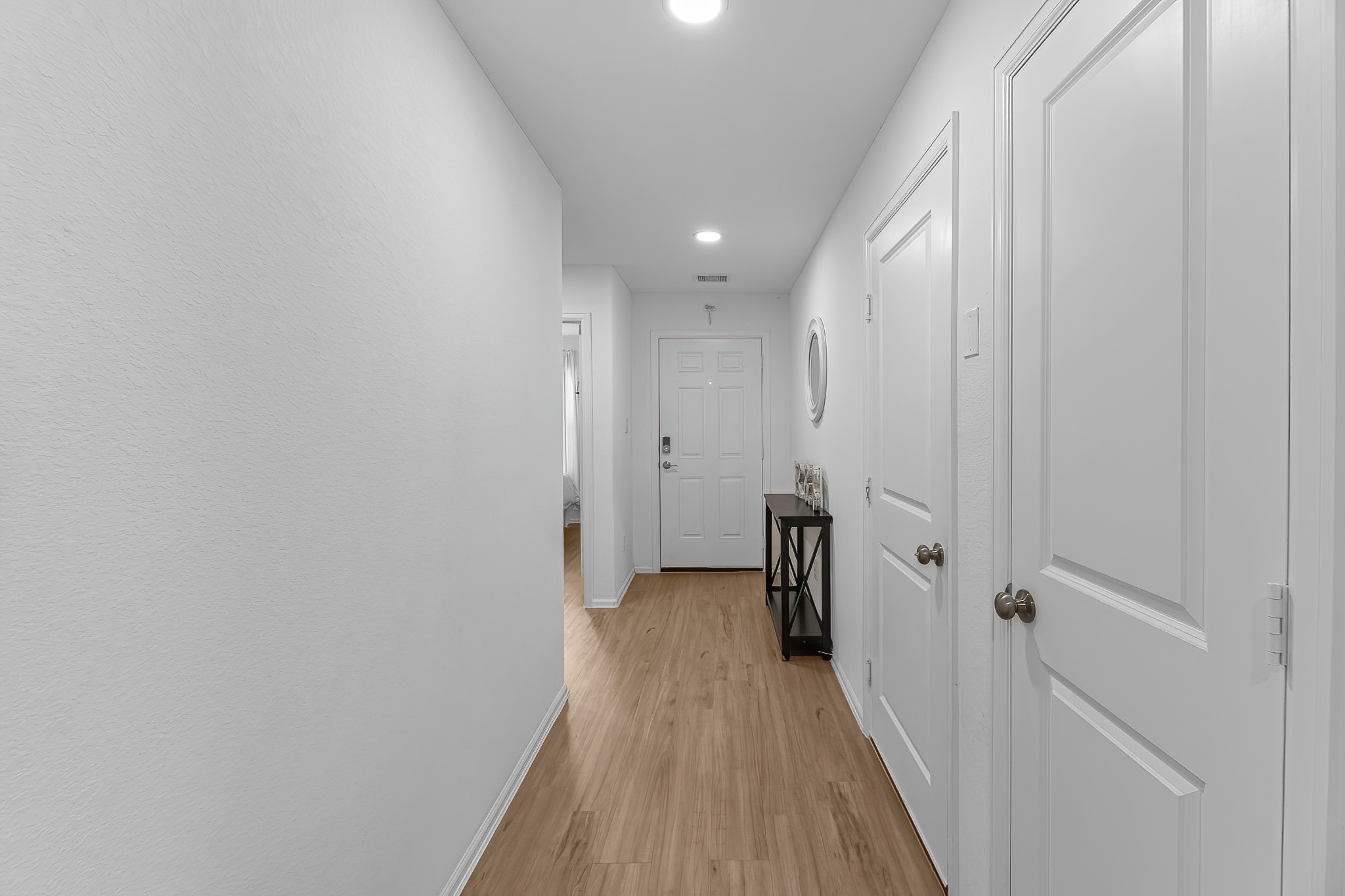 444 Maple Bend Lane La Marque, TX 77568 - Photo 4 of 32 a view of a hallway with wooden floor and a bathroom