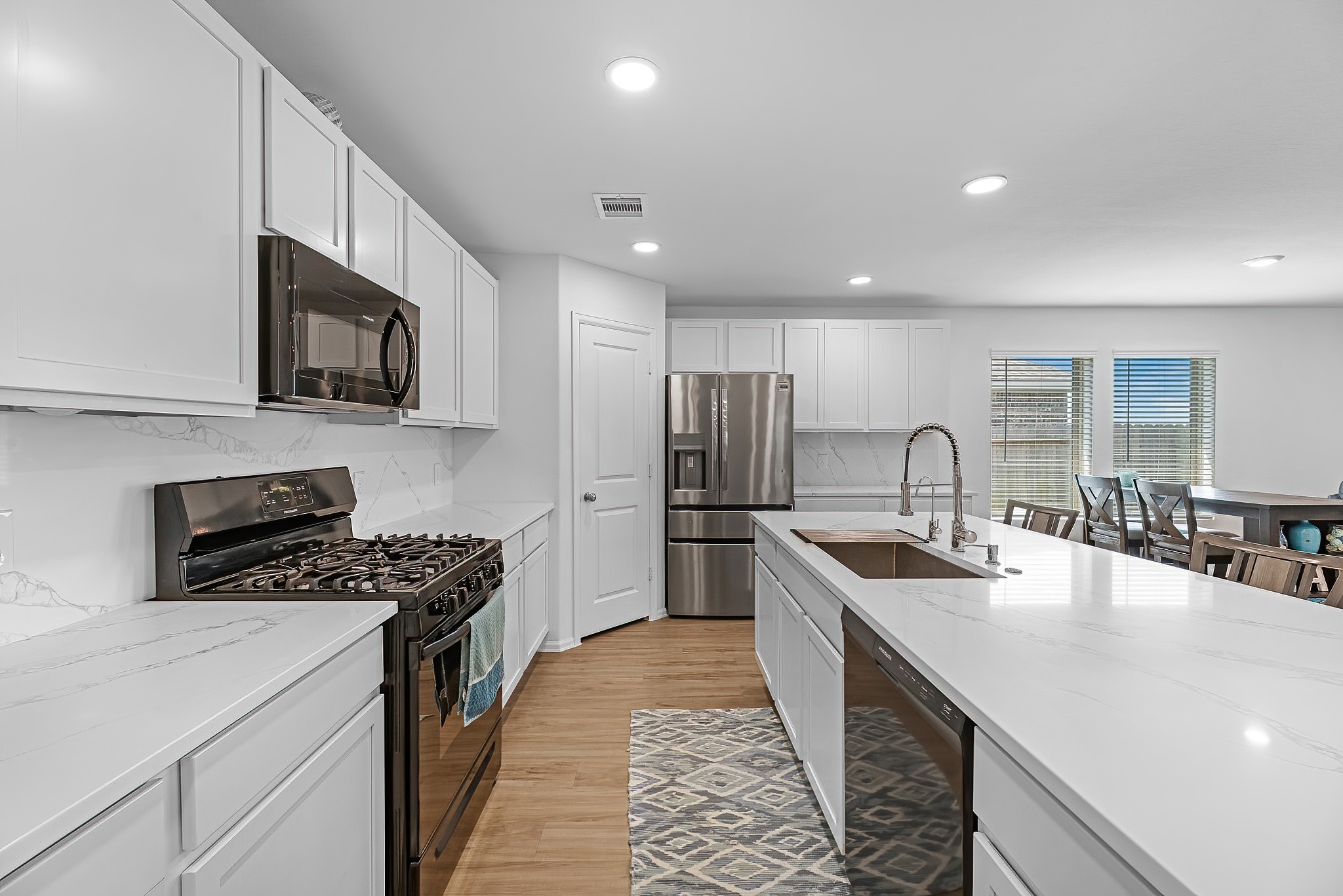 444 Maple Bend Lane La Marque, TX 77568 - Photo 6 of 32 a kitchen with stainless steel appliances granite countertop a sink stove microwave refrigerator and cabinets