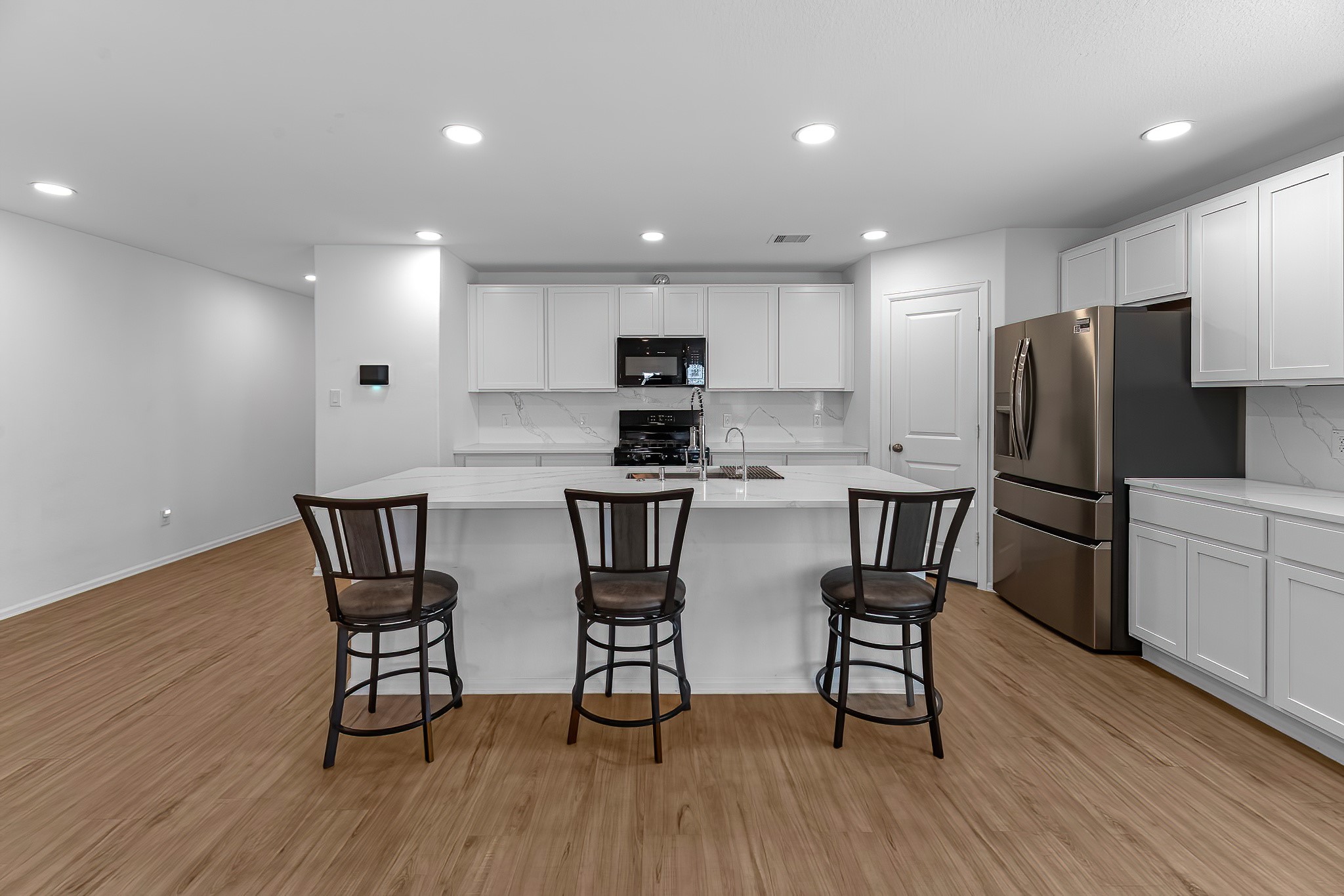 444 Maple Bend Lane La Marque, TX 77568 - Photo 7 of 32 a kitchen with stainless steel appliances a dining table chairs refrigerator and microwave