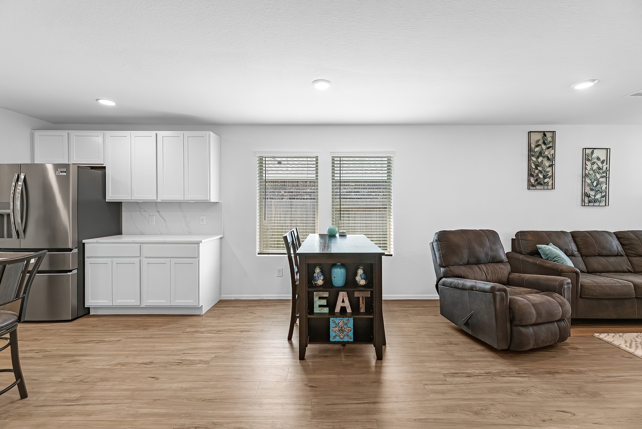 444 Maple Bend Lane La Marque, TX 77568 - Photo 9 of 32 a living room with furniture and a dining table with kitchen island
