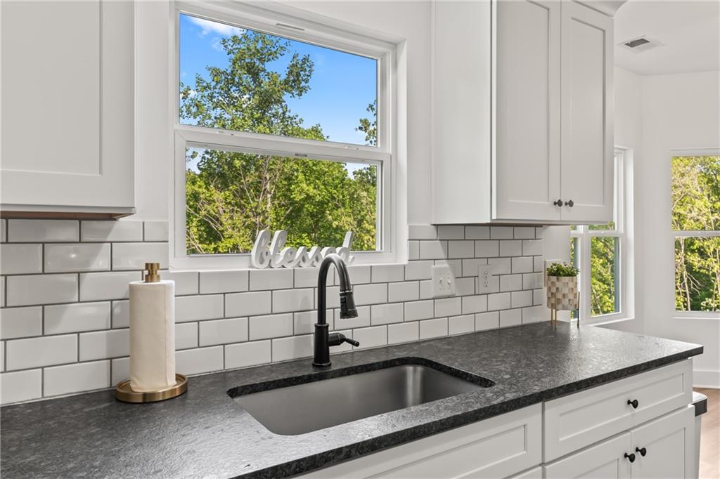 271 Moorings Run Jasper, GA 30143 - Photo 12 of 34 a kitchen with white cabinets a sink and a window