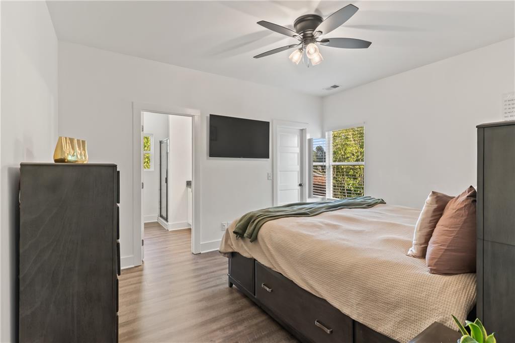 271 Moorings Run Jasper, GA 30143 - Photo 16 of 34 a bedroom with bed tv and a chandelier