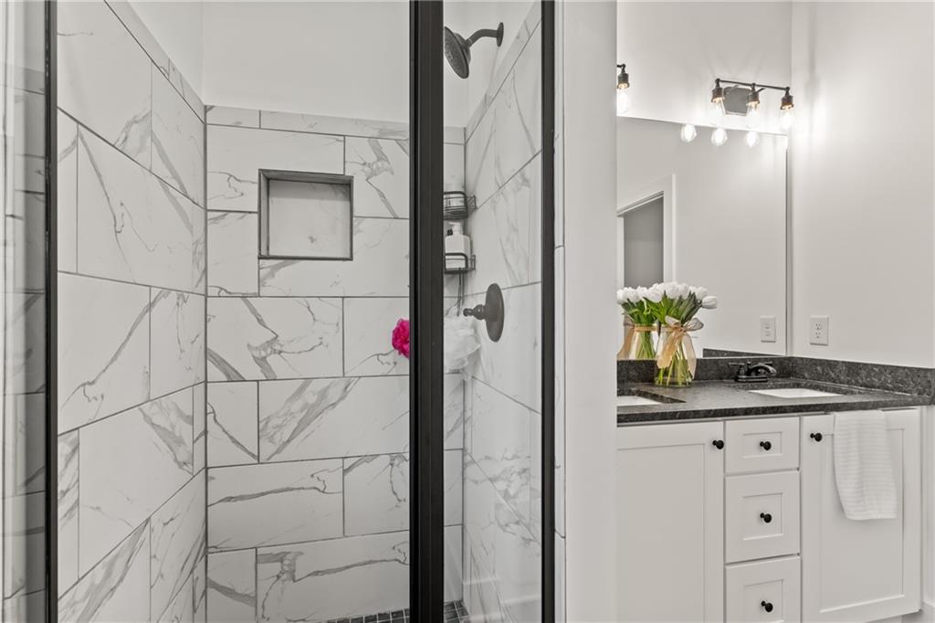 271 Moorings Run Jasper, GA 30143 - Photo 19 of 34 a bathroom with a granite countertop sink a vanity and a mirror