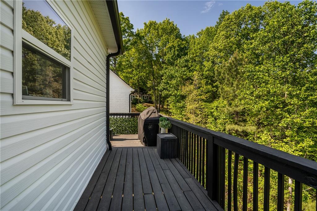 271 Moorings Run Jasper, GA 30143 - Photo 32 of 34 a balcony with wooden floor and trees in the back