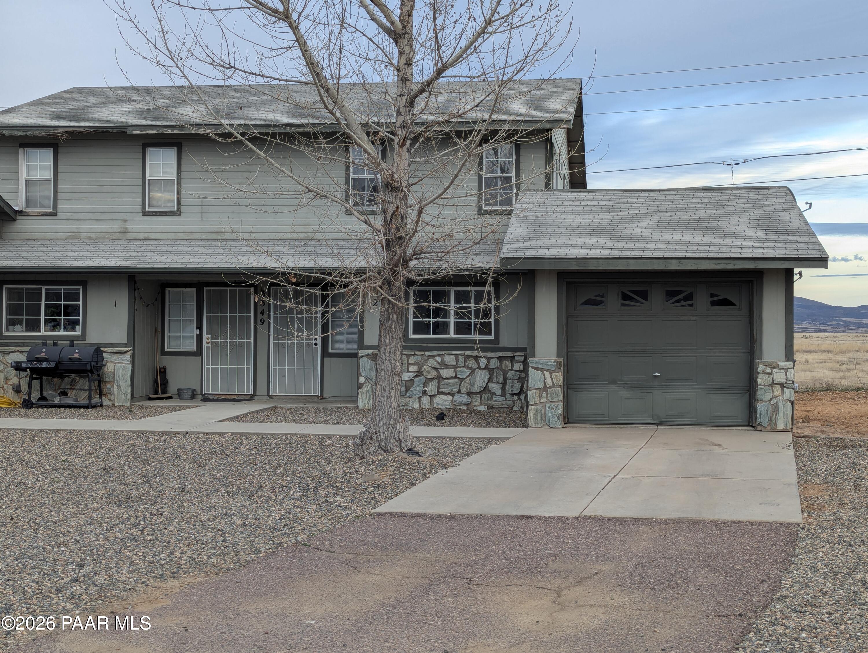 3349 North Yavapai Road East, Unit B Prescott Valley, AZ 86314 - Photo 1 of 1 a front view of a house with garage