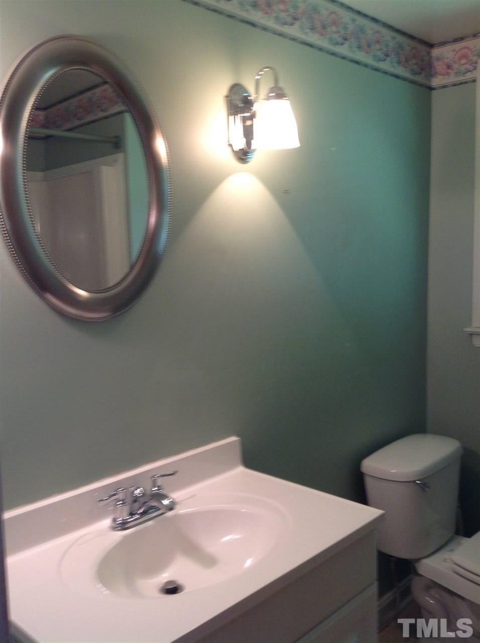 907 Mills Street Raleigh, NC 27608 - Photo 12 of 13 a bathroom with a sink and a mirror