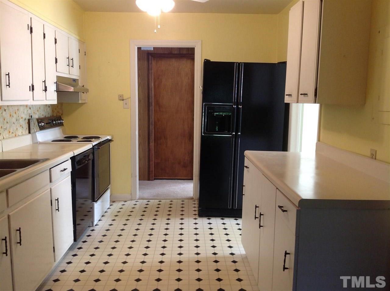 907 Mills Street Raleigh, NC 27608 - Photo 4 of 13 a kitchen with granite countertop a refrigerator and a sink