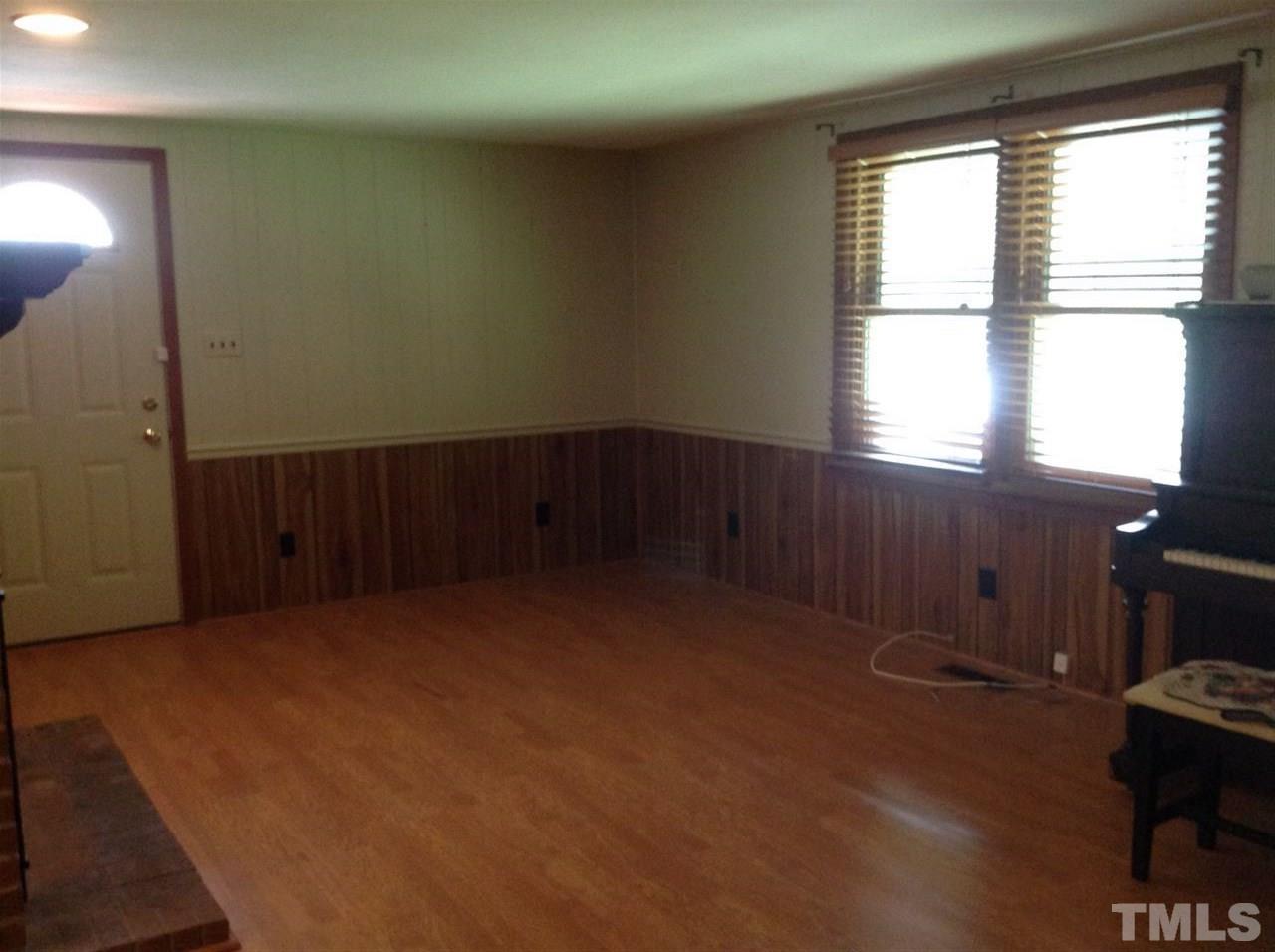 907 Mills Street Raleigh, NC 27608 - Photo 7 of 13 an empty room with wooden floor and windows