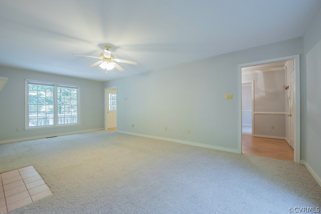 10400 White Rabbit Road North Chesterfield, VA 23235 - Photo 18 of 50 an empty room with chandelier fan and windows