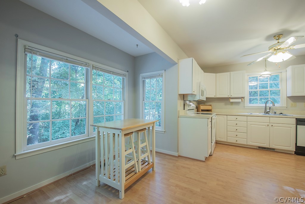 10400 White Rabbit Road North Chesterfield, VA 23235 - Photo 21 of 50 a kitchen with window wooden cabinets and sink
