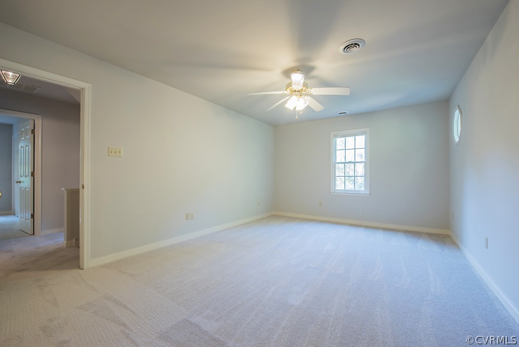 10400 White Rabbit Road North Chesterfield, VA 23235 - Photo 32 of 50 an empty room with chandelier fan and windows
