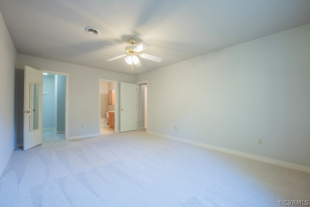 10400 White Rabbit Road North Chesterfield, VA 23235 - Photo 33 of 50 an empty room with a ceiling fan and a window