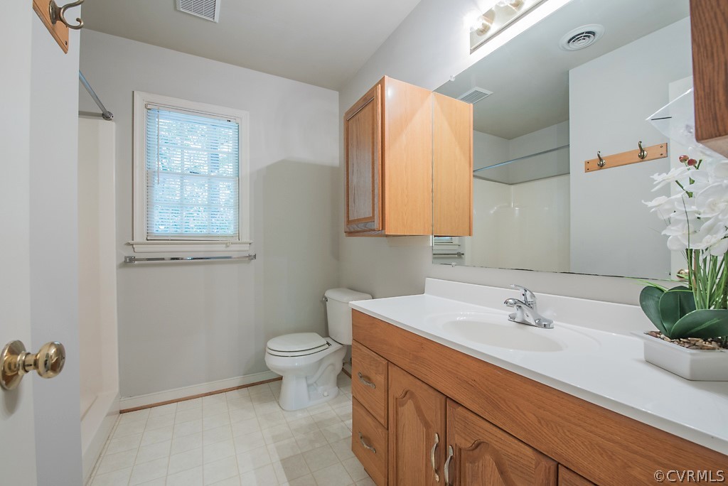 10400 White Rabbit Road North Chesterfield, VA 23235 - Photo 35 of 50 a bathroom with a sink a toilet and a mirror