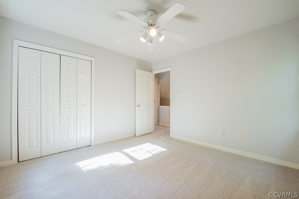 10400 White Rabbit Road North Chesterfield, VA 23235 - Photo 38 of 50 an empty room with a ceiling fan and closet area