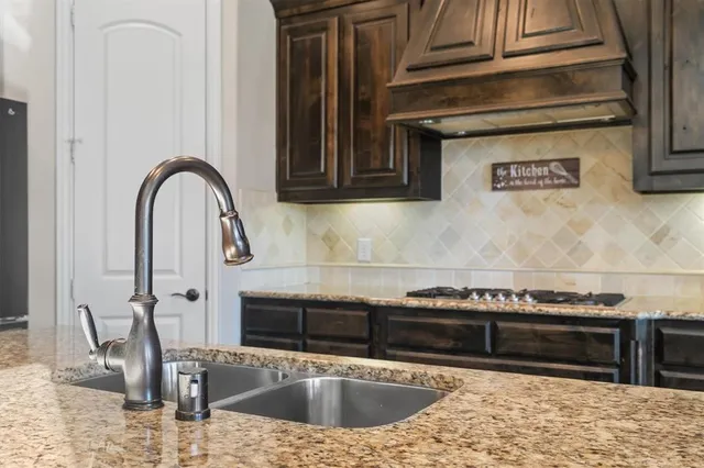 a kitchen with a sink and a stove