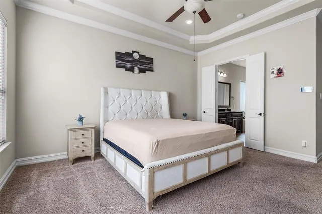 a bed room with a bed and a ceiling fan