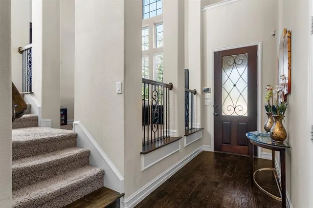 a view of a hallway with wooden floor and furniture