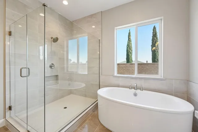 a white bath tub sitting next to a shower