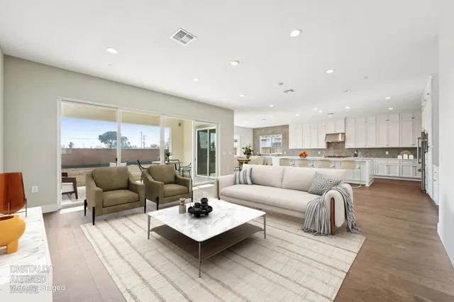 a living room with furniture and a view of kitchen