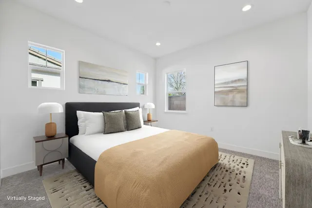 a bedroom with a bed and a painting on the wall