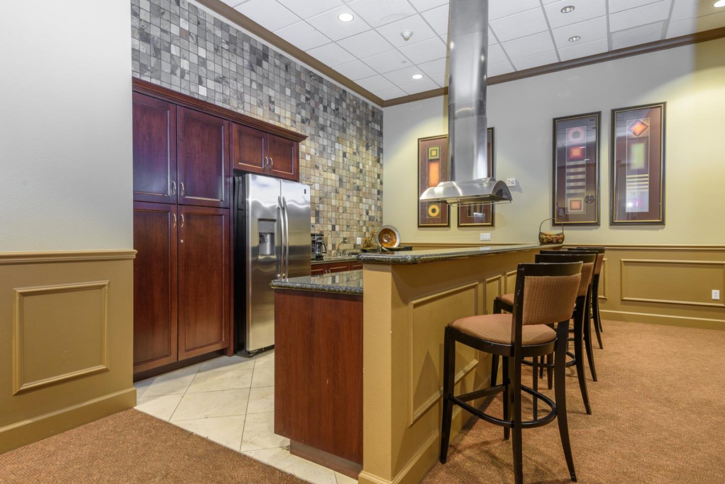 88 South Broadway, Unit 3112 Millbrae, CA 94030 - Photo 19 of 20 a dining hall with granite countertop a refrigerator and cabinets