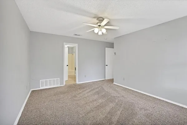 a view of an empty room with a fan