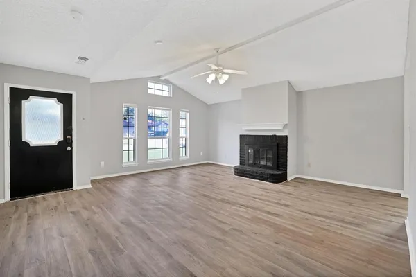 wooden floor in an empty room with a fireplace