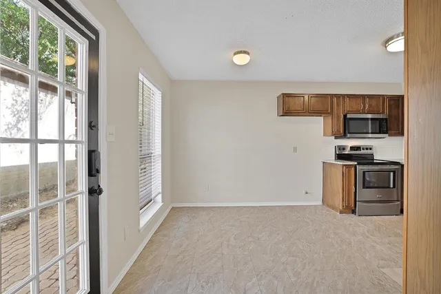 a view of kitchen with microwave and refrigerator