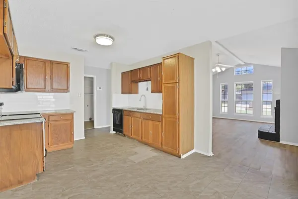 a spacious bathroom with a granite countertop sink mirror and a bathtub