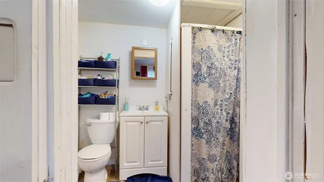 a bathroom with a toilet sink and vanity