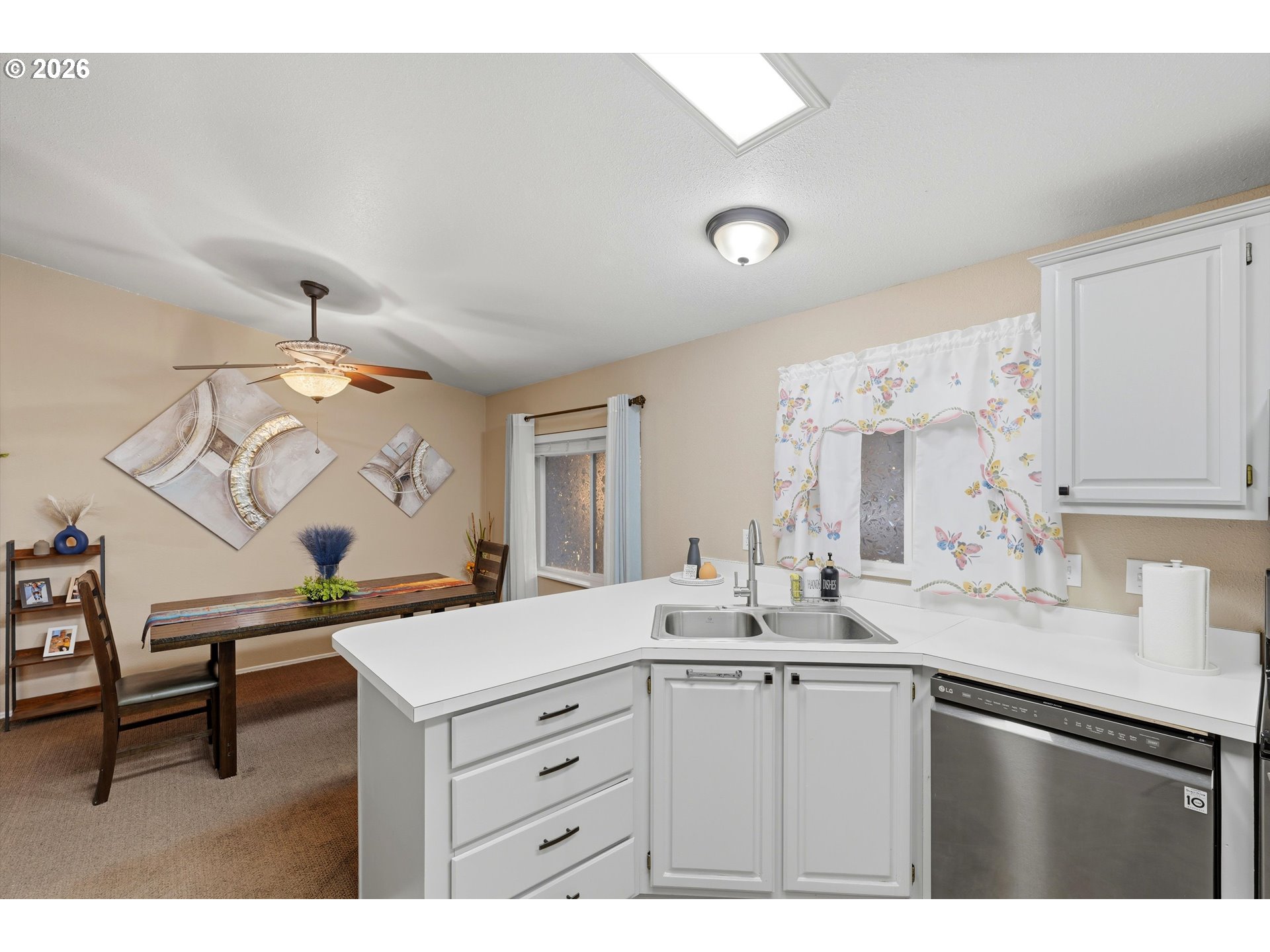 369 Gun Club Road, Unit 88 Woodland, WA 98674 - Photo 7 of 17 a kitchen with a sink cabinets and wooden floor