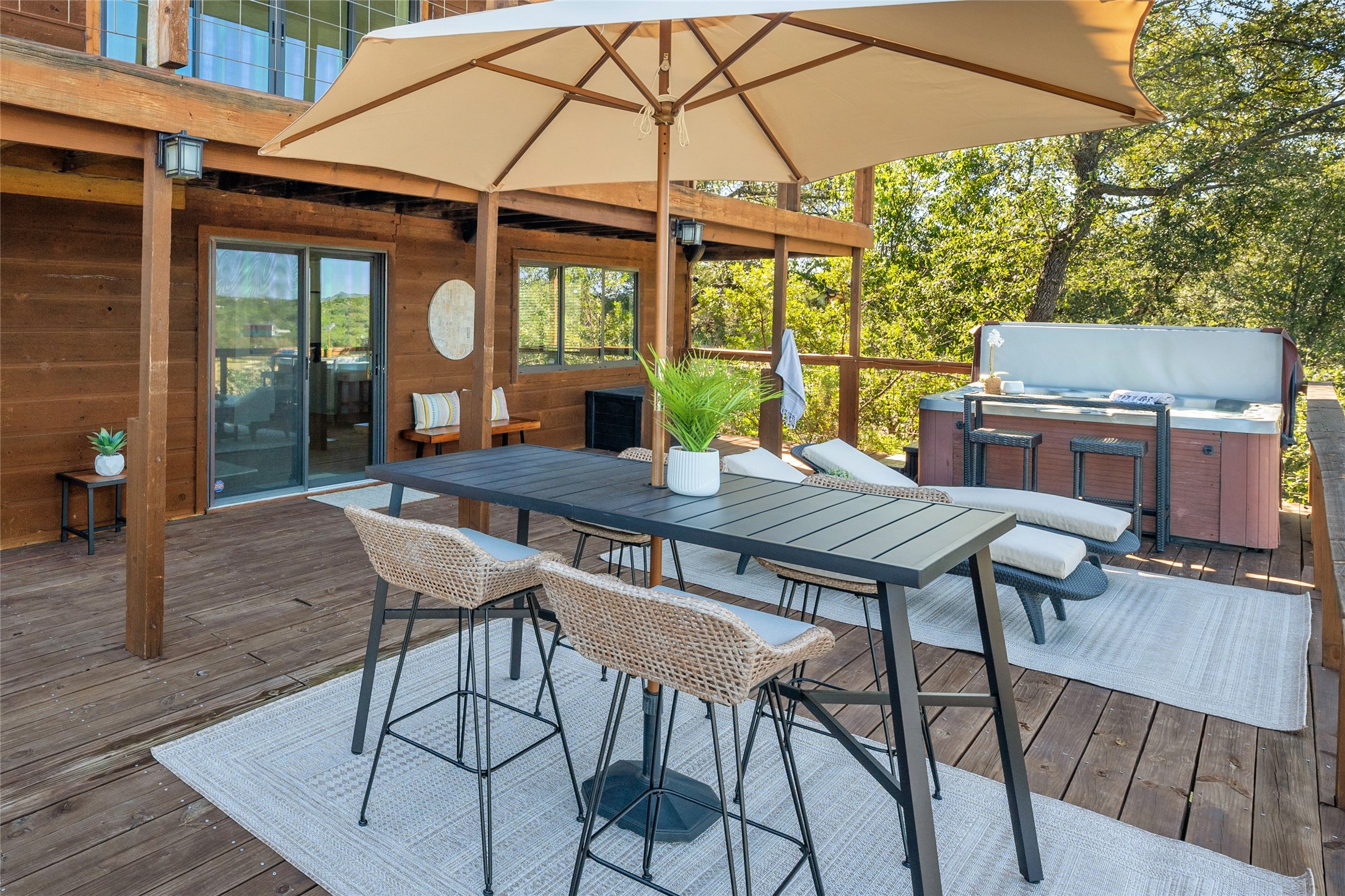 19645 Lakehurst Loop Spicewood, TX 78669 - Photo 23 of 40 Deck with a hot tub and outdoor dining area