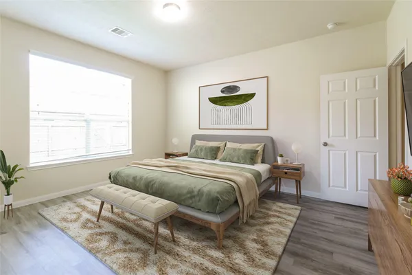 a view of a room with wooden floor and a ceiling fan