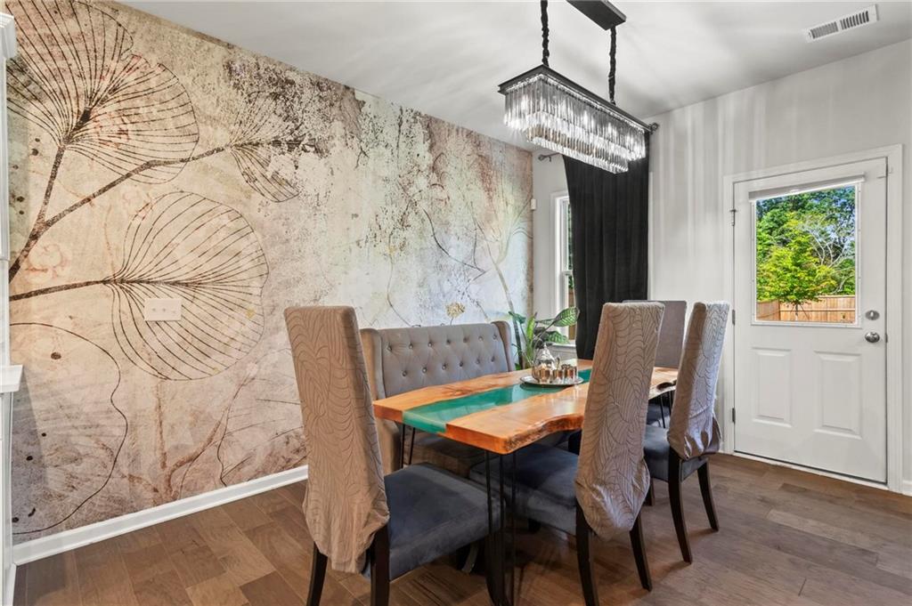 113 Poppy Street McDonough, GA 30253 - Photo 15 of 36 a view of a dining room with furniture window and wooden floor