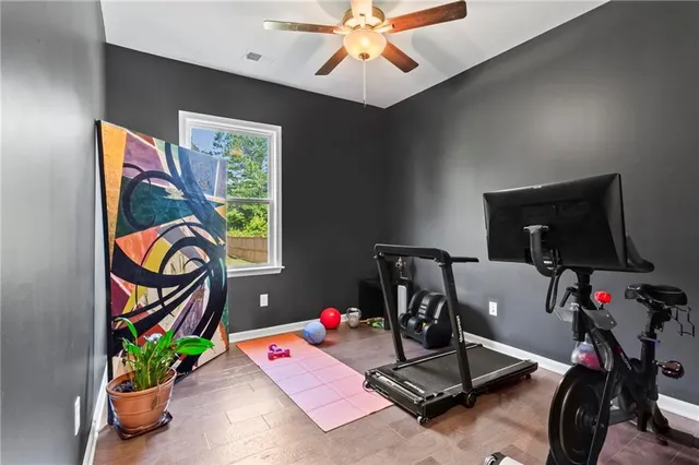a view of a workspace with furniture and a flat screen tv