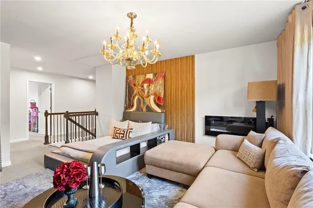 a living room with furniture and a chandelier