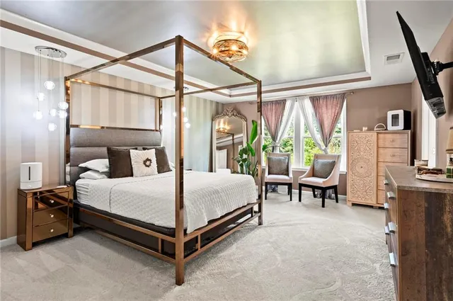 a bedroom with a bed and large mirror with window