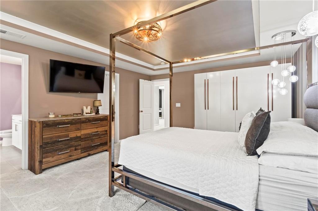 113 Poppy Street McDonough, GA 30253 - Photo 22 of 36 a bedroom with a bed and a flat screen tv