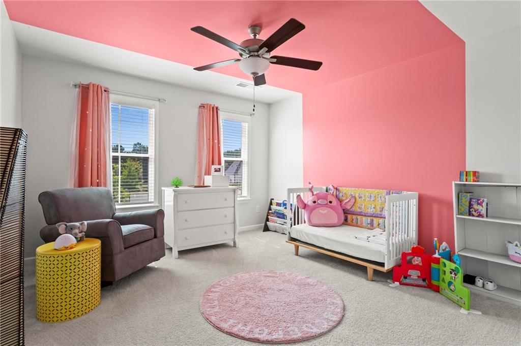 113 Poppy Street McDonough, GA 30253 - Photo 25 of 36 a bedroom with furniture and a couch