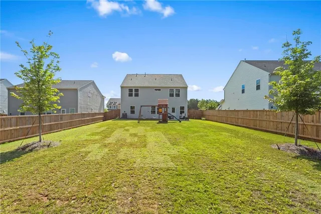 a swimming pool with outdoor seating and yard