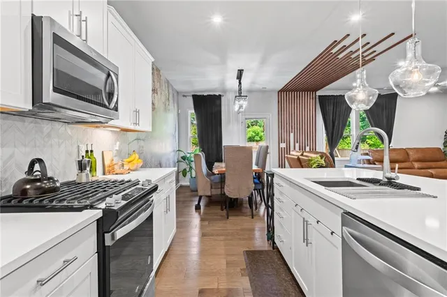 a kitchen with a sink stove and cabinets