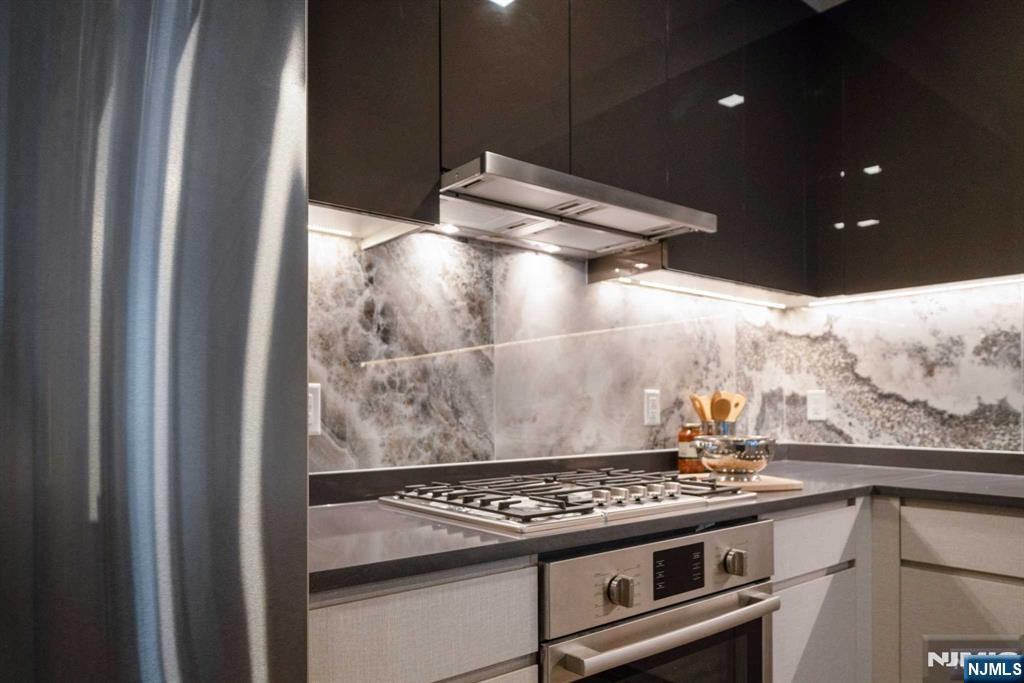 7101 River Road, Unit 304A North Bergen, NJ 07047 - Photo 7 of 24 a stove top oven sitting inside of a kitchen