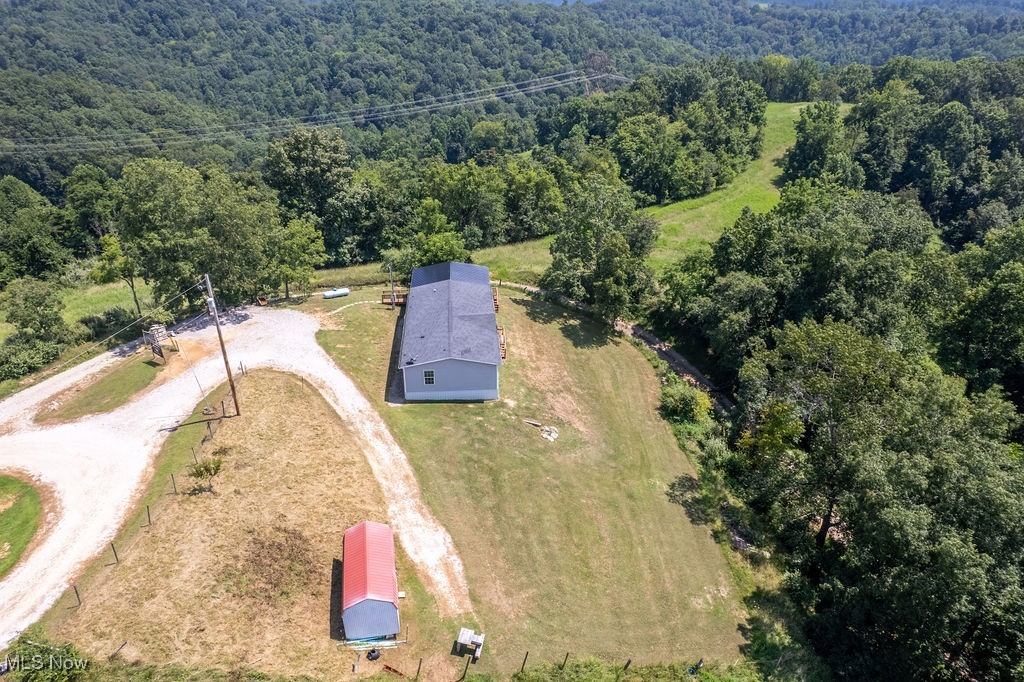 560 Wine Road Elizabeth, WV 26143 - Photo 43 of 50 Aerial view of property and surrounding area featuring a heavily wooded area